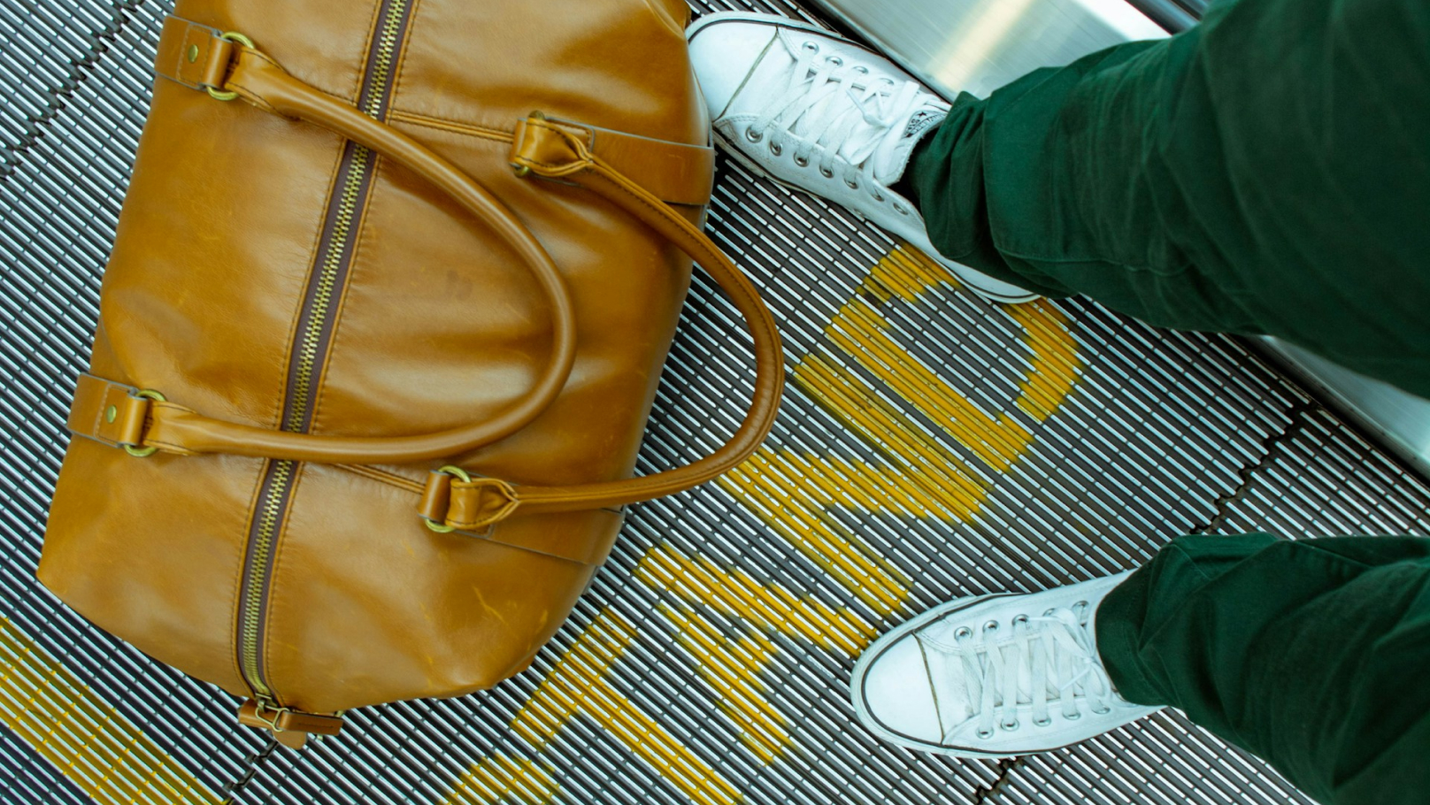 Reizigers met tas op een rolpad in de vertrekhal van een luchthaven