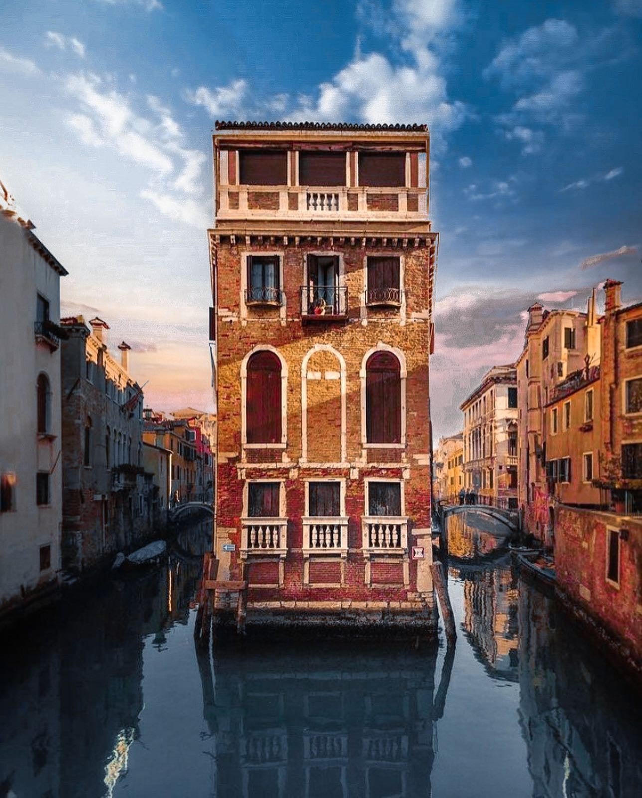 The historic Palazzo Teta stood between two canals at sunset