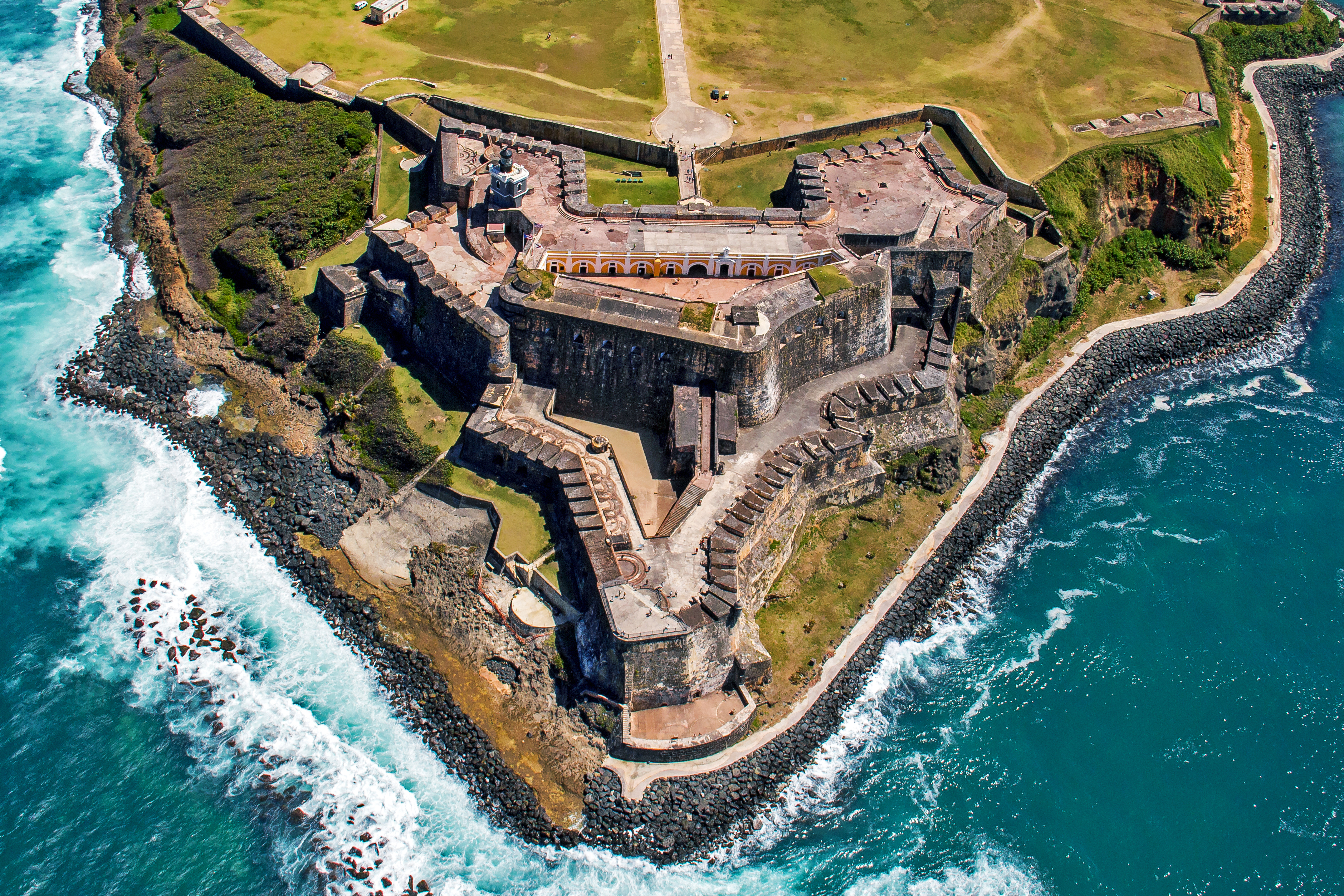 Aerial view of the 16th-century fortress Castillo San Felipe del Morro with waves crashing against its walls