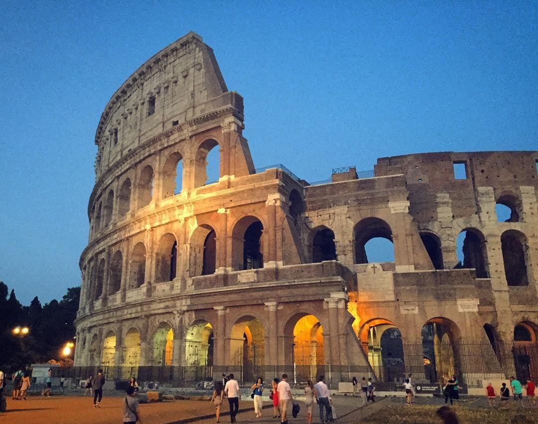 Evening view of the Colosseum in Rome with people in foreground