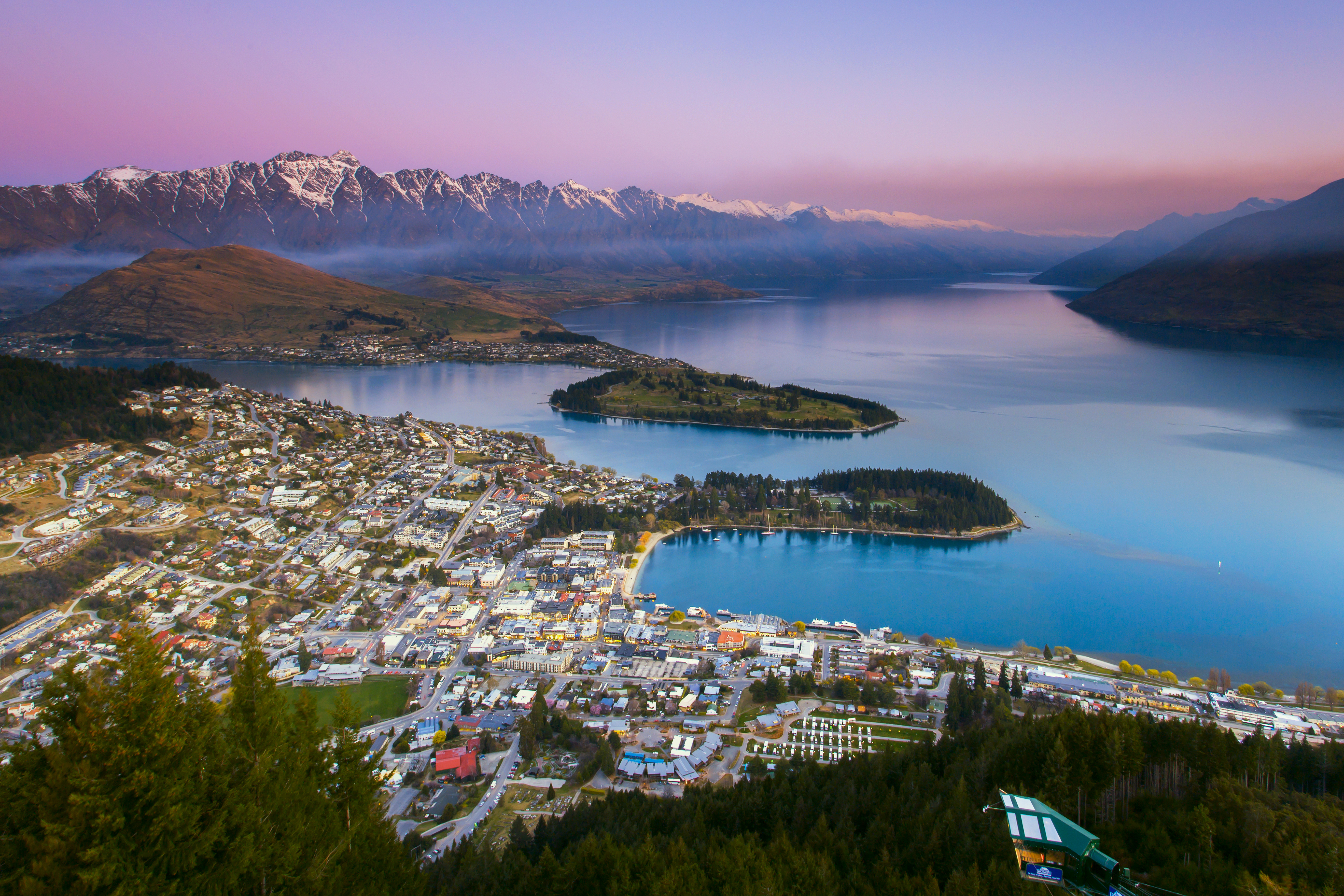 Aerial picture of Queenstown at dusk with Lake Wakatipu and Southern Alps in the background