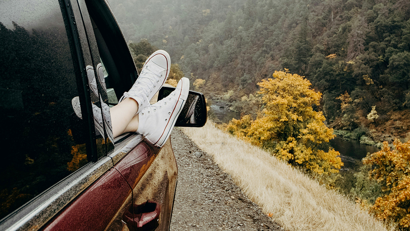 Feet hanging out of car window